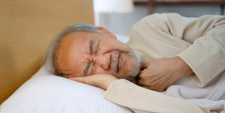Senior Man Sleeping Peacefully in Comfortable Bed at Memory Care Facility