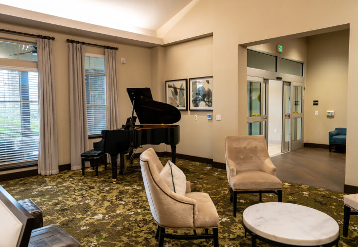 Comfortable Bedroom With Neutral Bedding Memory Care Rocklin CA grand-piano-area