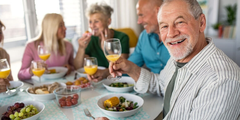 Elderly Friends Sharing Meal and Laughter at Assisted Living Facility