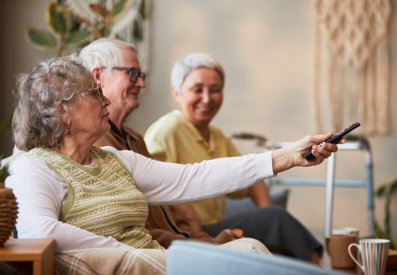 Happy Elderly Women Enjoying Outdoor Knitting Activity Memory Care Facility residents-assisted-living