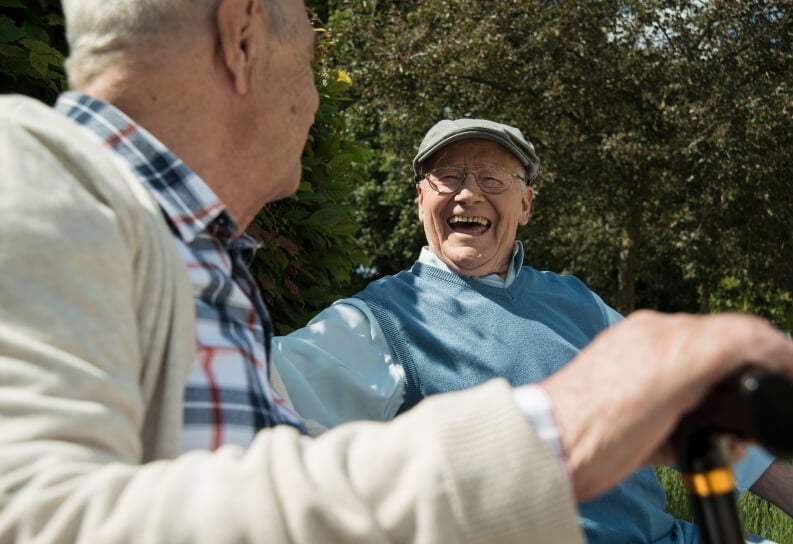 Joyful Grandfather Holding Baby Enjoying Family Visit Memory Care Facility residents-memory-care